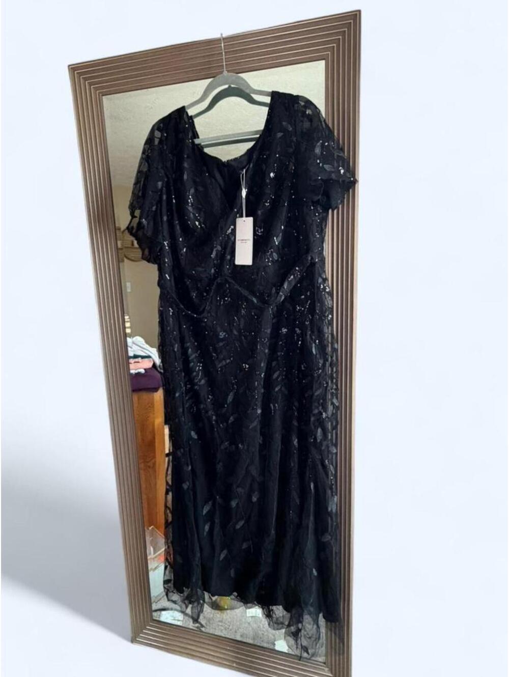 Black sequin formal dress with flutter sleeve. Size: 26